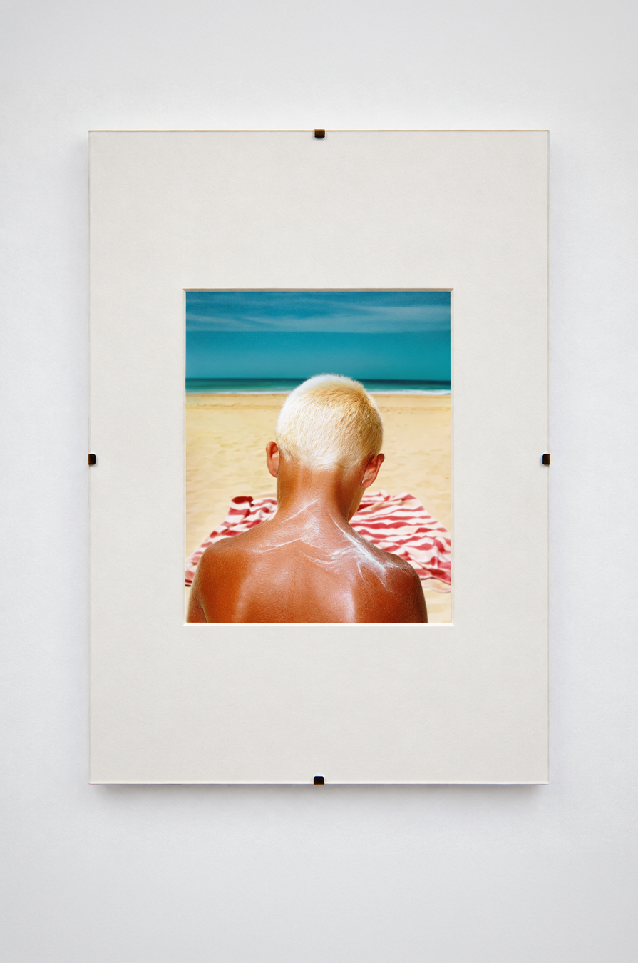 Beach portrait from behind, sunscreen across the shoulders, matted print